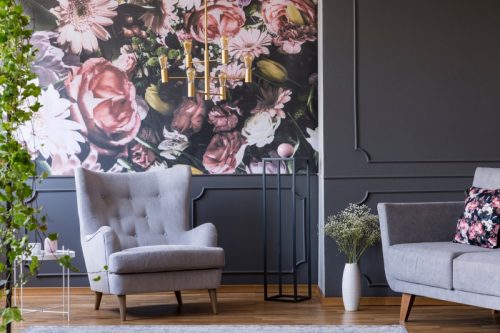 living room with floral wallpaper, gray walls, and gray chair
