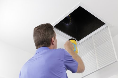 man doing hvac inspection ways to bring down a/c bill