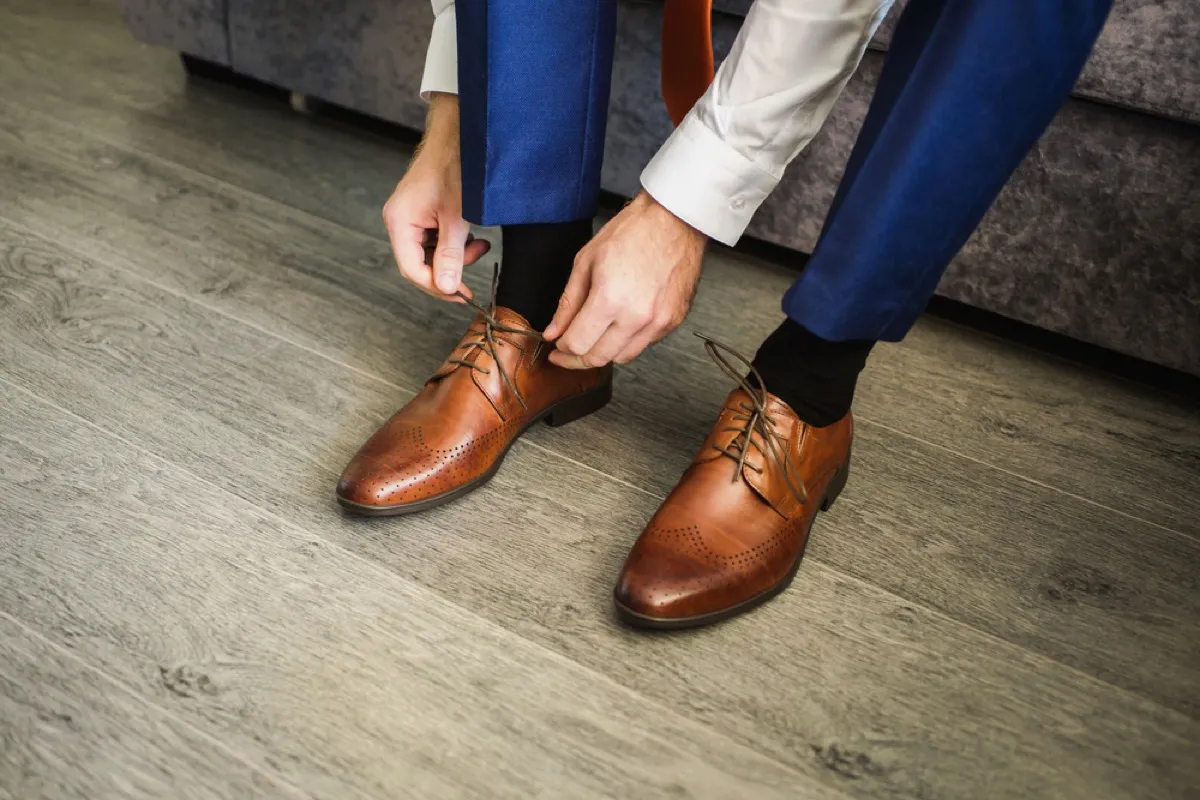 man putting on oxfords, look better after 40