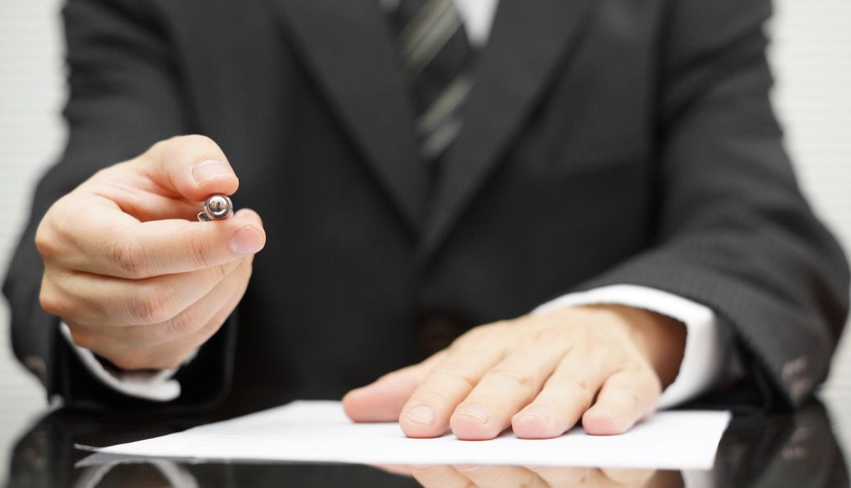 man holding pen to sign contract, dad jokes