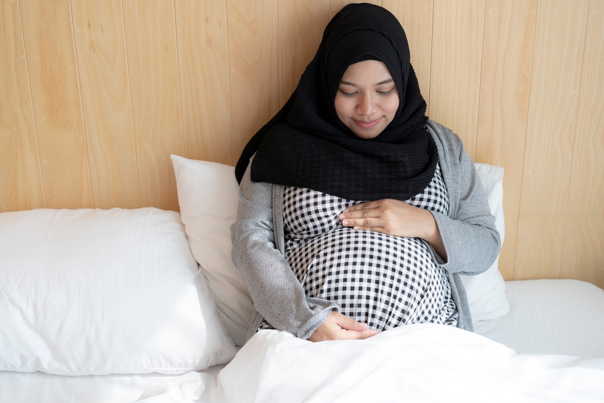 Pregnant Muslim Woman in Bed Ramadan