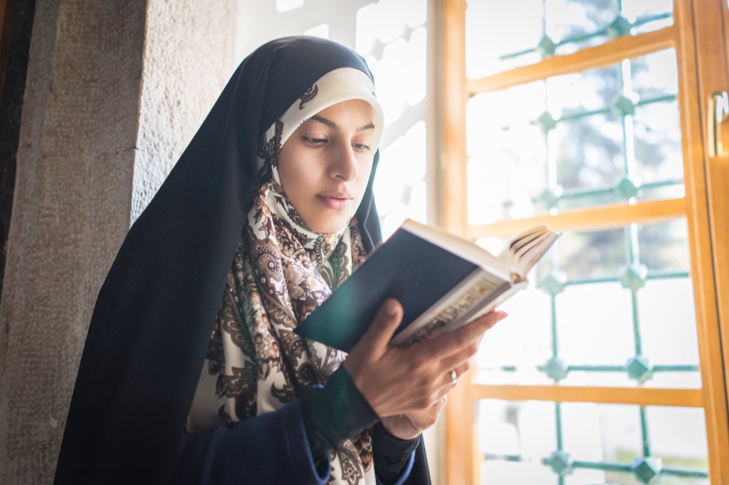 Muslim Woman Reading at a Mosque Ways Ramadan is Celebrated