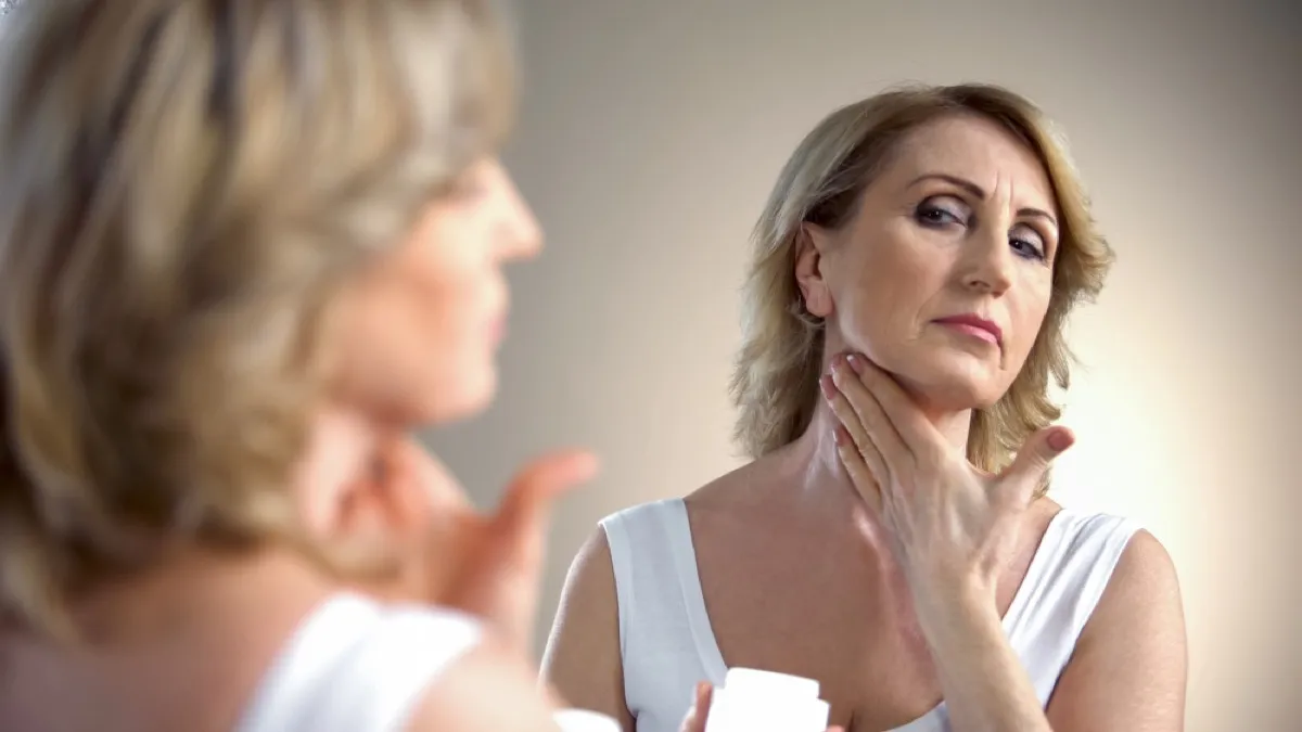 older woman applying neck cream, look better after 40