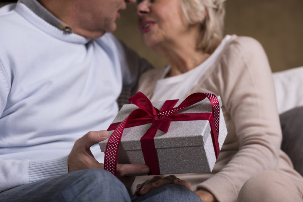 older couple exchanging gifts, relationship white lies