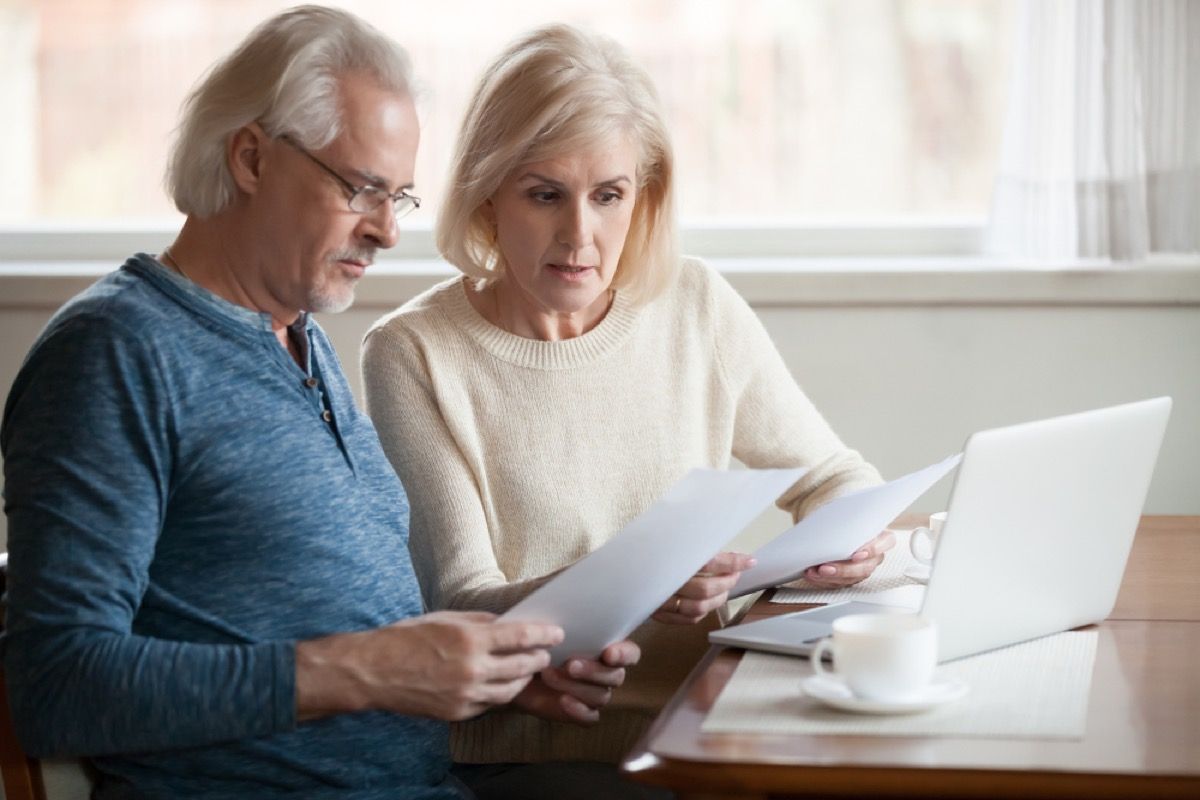 older couple going over financial documents, things you should never say to your spouse