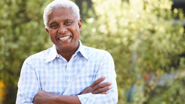 older black man standing outdoors, look better after 40