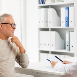 older man at checkup, health questions after 40
