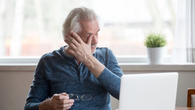 middle aged man rubbing eyes, health questions after 40