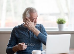 middle aged man rubbing eyes, health questions after 40