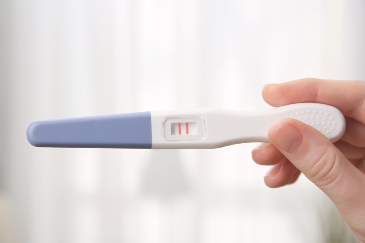 woman holding pregnancy test ,how parenting has changed