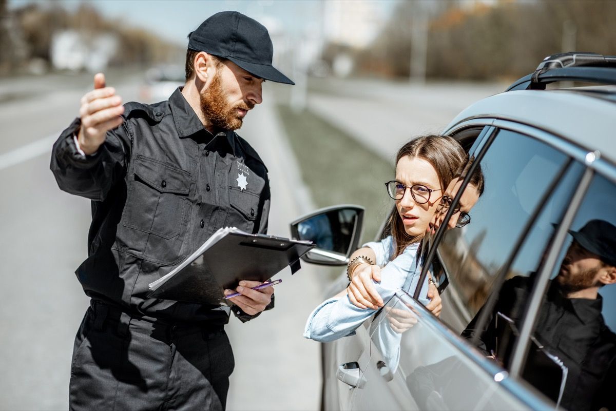 Woman in her car pulled over by police.