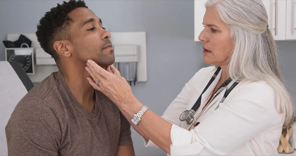 thyroid problems man getting checkup by doctor