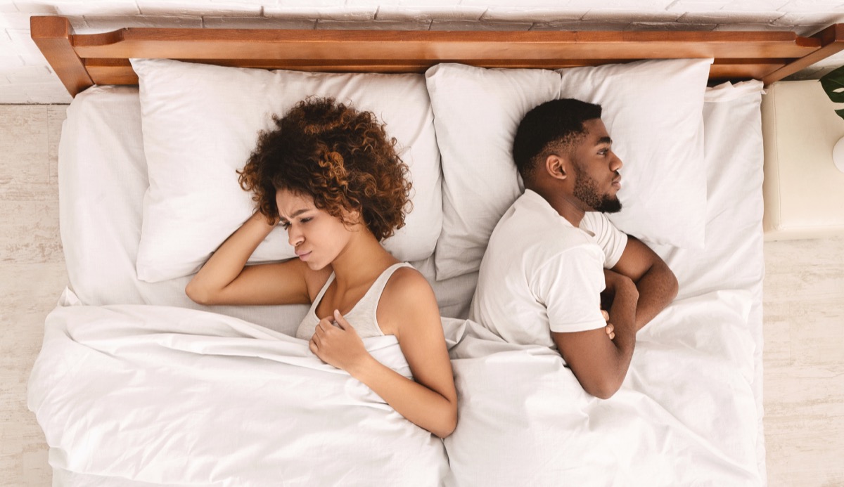 upset couple in bed sleeping angry, things you should never say to your spouse
