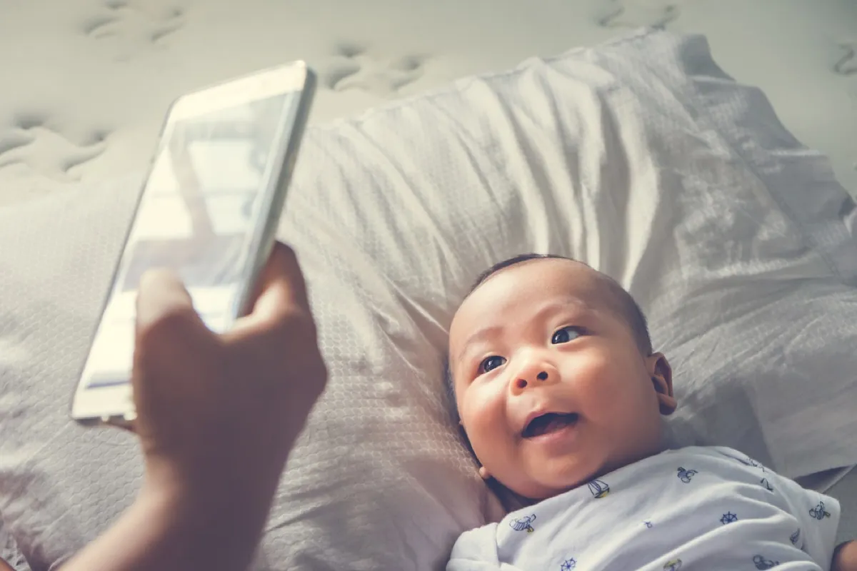 woman photographing baby, parenting tips