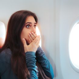 woman with motion sickness on airplane