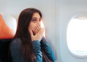 woman with motion sickness on airplane