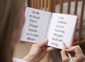 woman writing down a list of baby names, things that annoy grandparents