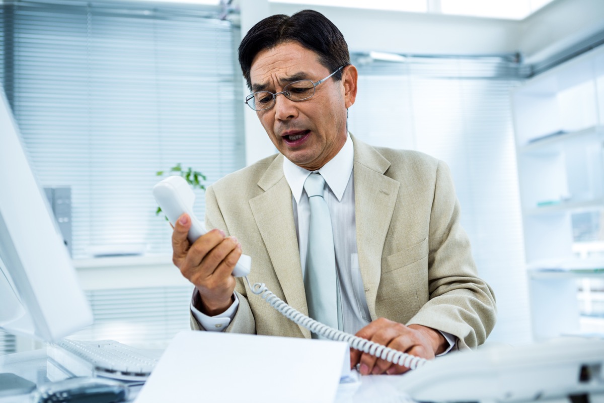 Angry Asian business man middleaged on phone, things not to say to customer service