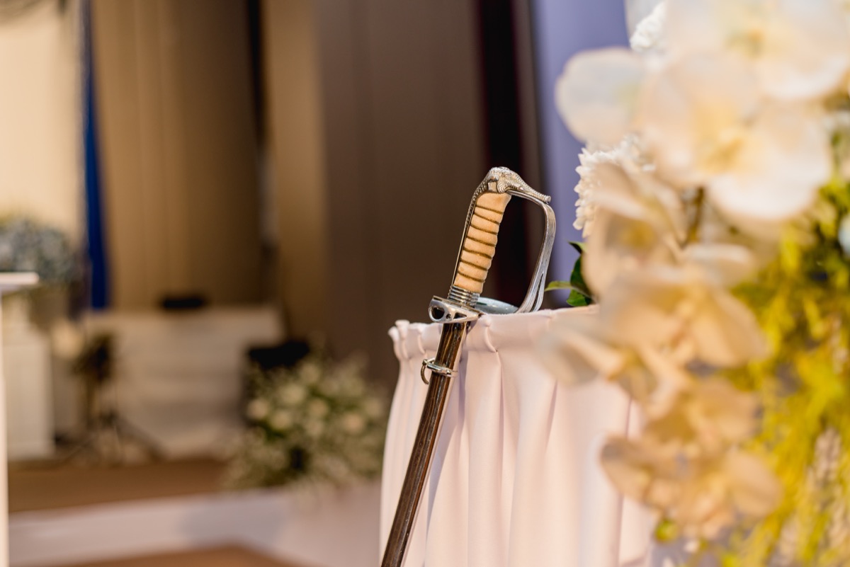 sword rests on table at wedding, craziest things brides and grooms have ever done at weddings