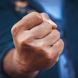 man with angry balled up fist, customer service rep