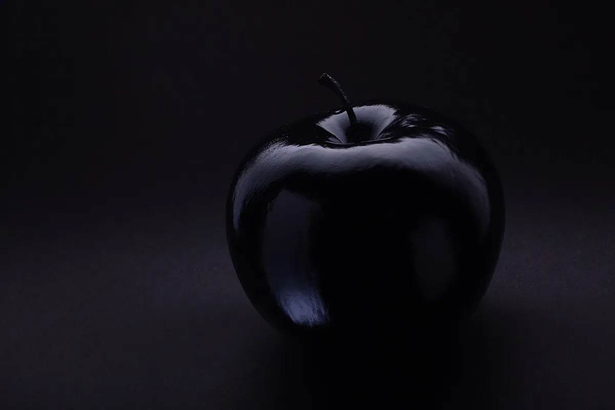 black apple on a black background