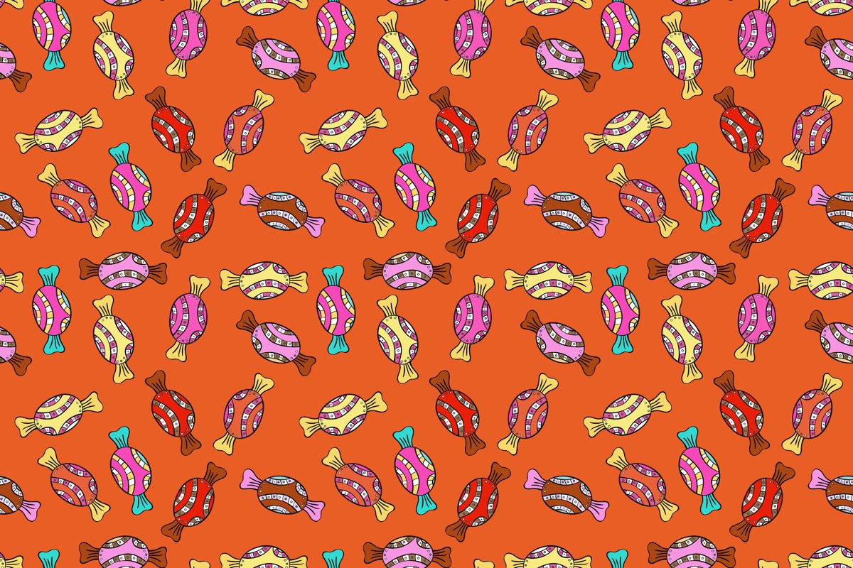 orange wallpaper with little pieces of all different colored candy