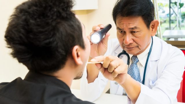 Doctor Examining a Patient's Mouth Tongue Health