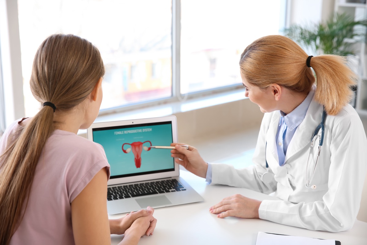 Doctor teacher woman about her body pointing to the uterus
