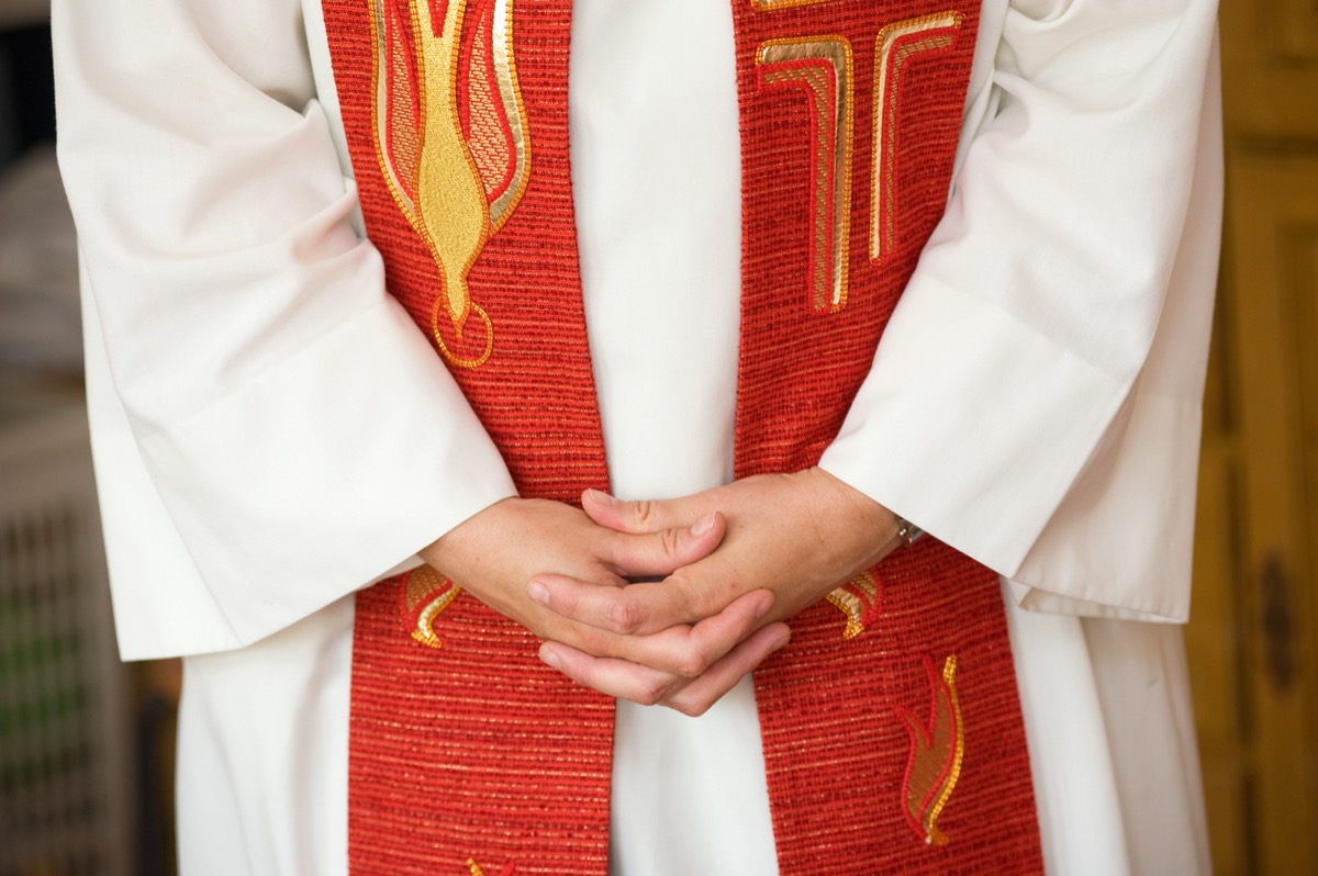 folded hands of a female priest, achievements women