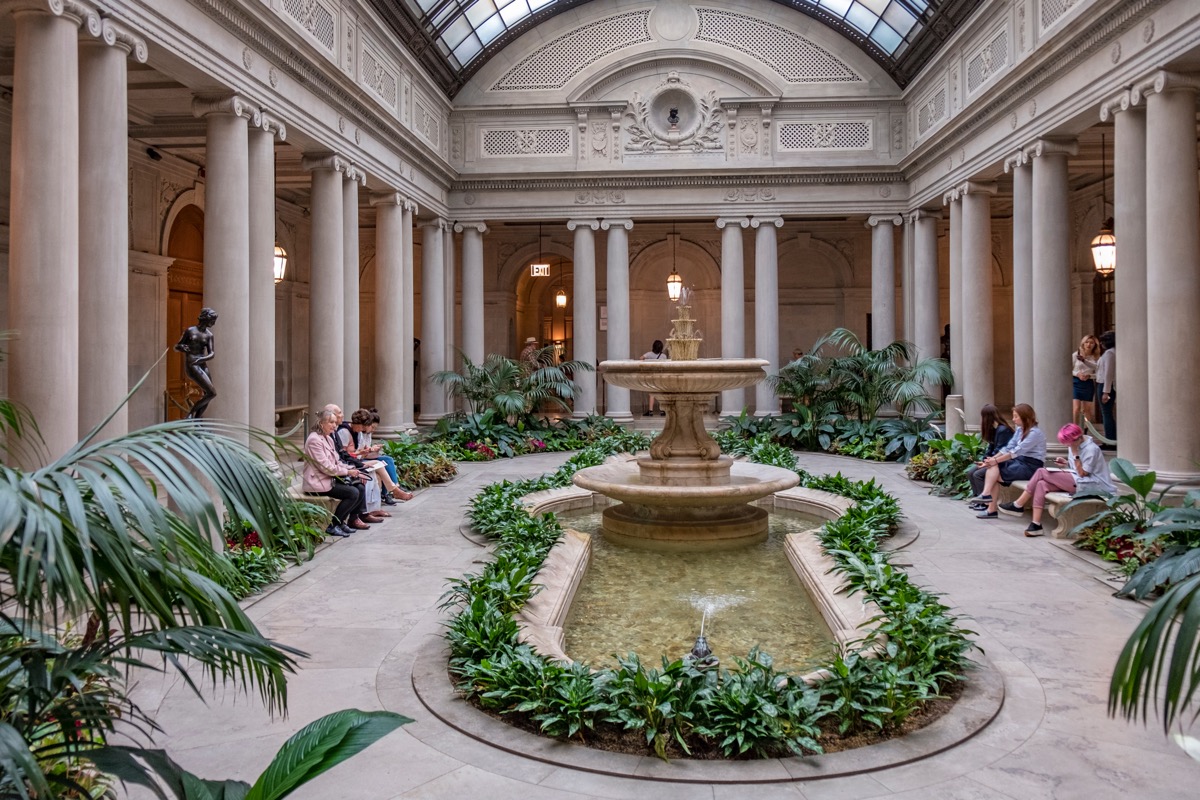 the inside of the frick collection with people sitting down
