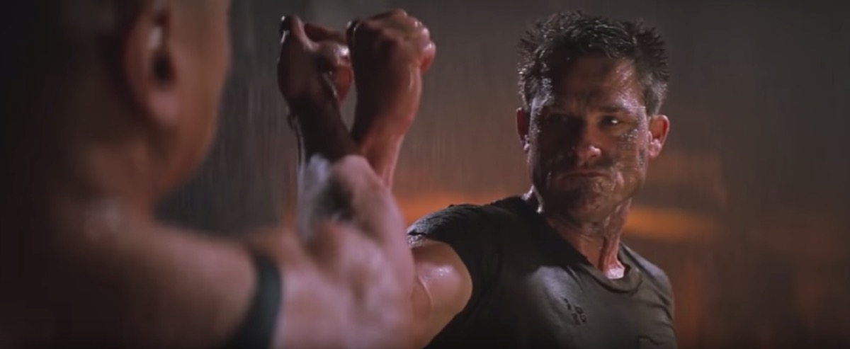 close up Kurt Russell's face in a fight