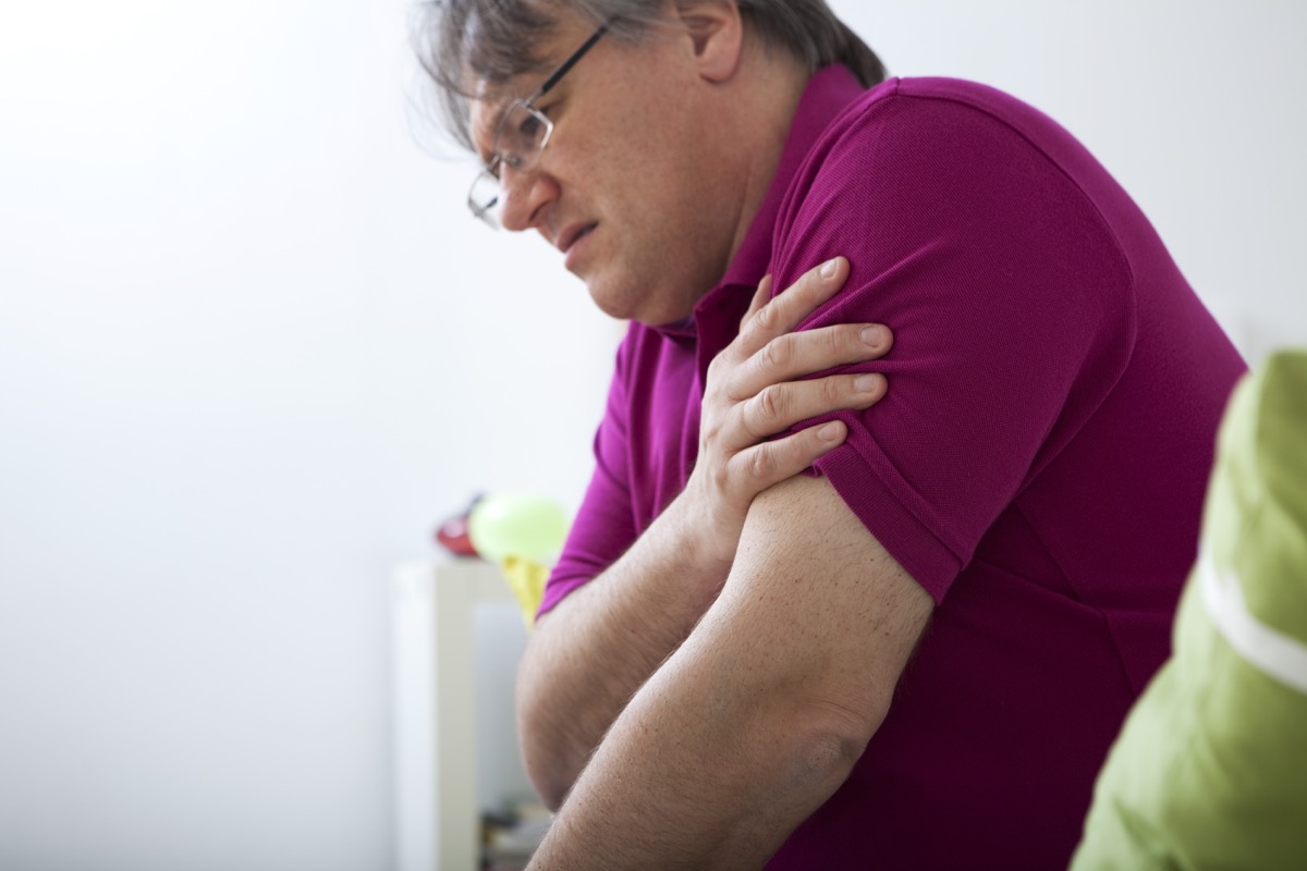 Man Clutching His Arm in Pain Misdiagnosed Men's Health Issues