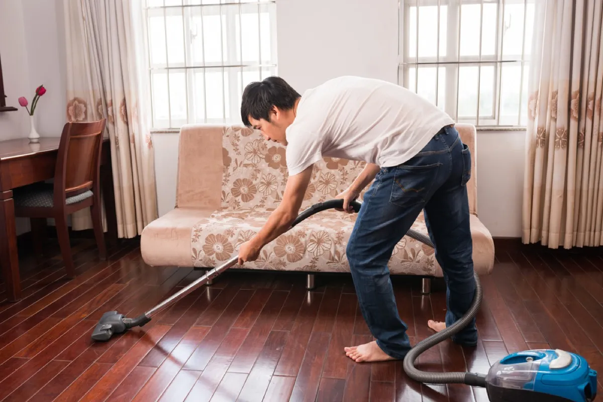 man vacuuming floors, easy home tips