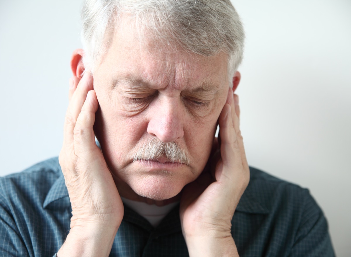 man with jaw pain and gray hair, health concerns over 40 for men
