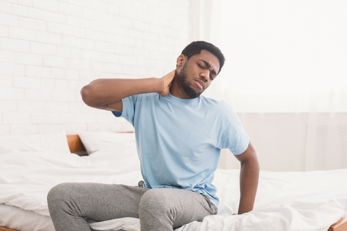 man with neck and back pain, signs you need a new mattress