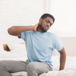 man with neck and back pain, signs your cold is serious