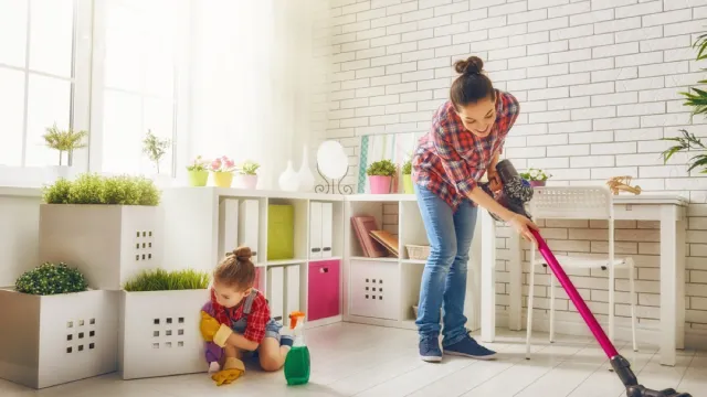 woman and child vacuuming floor and cleaning living room, vacuuming tips