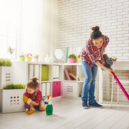 woman and child vacuuming floor and cleaning living room, vacuuming tips
