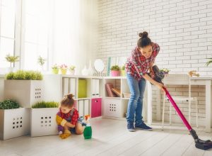 woman and child vacuuming floor and cleaning living room, vacuuming tips