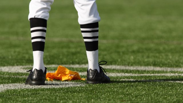 nfl referee standing on the field, female achievements