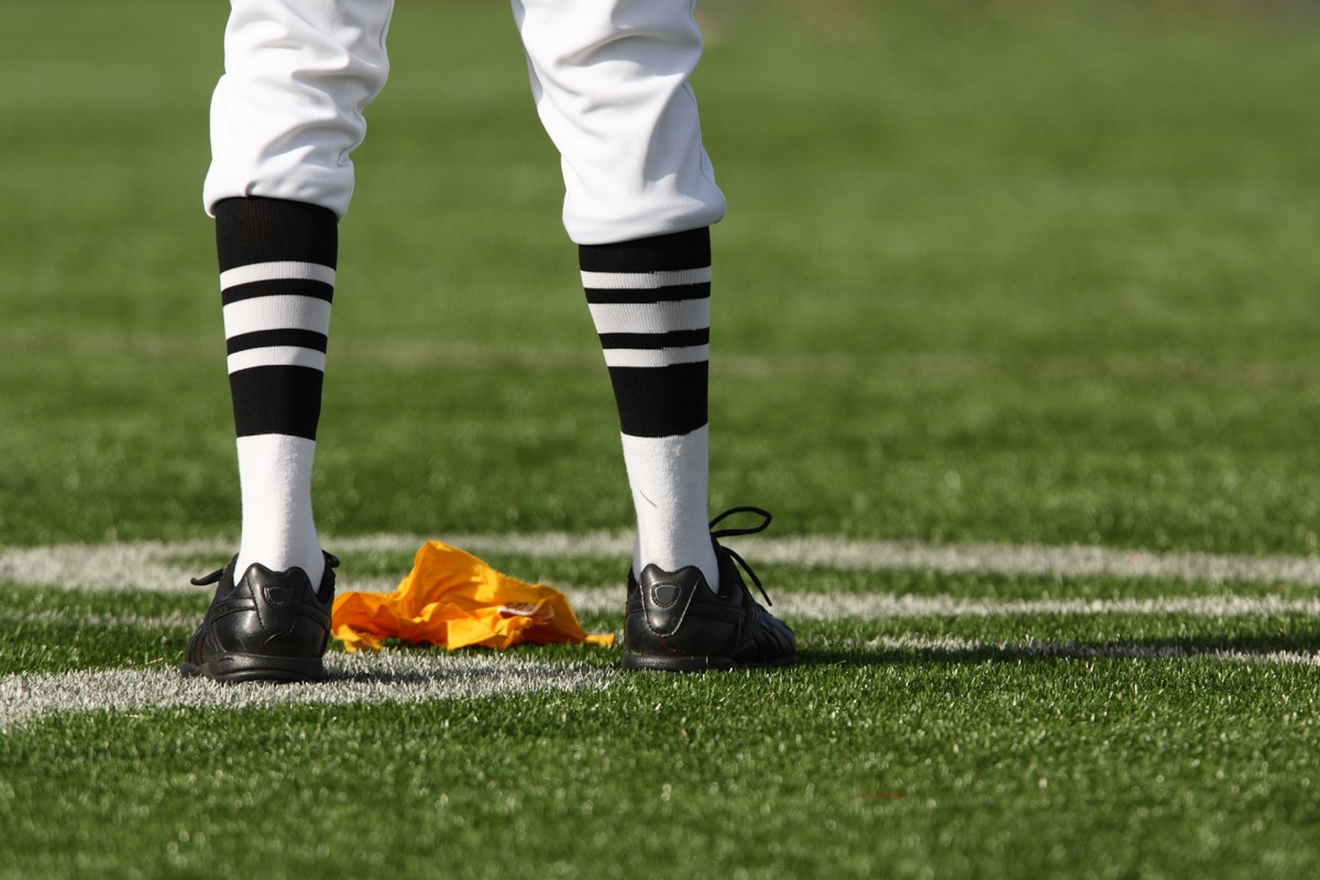 nfl referee standing on the field, female achievements