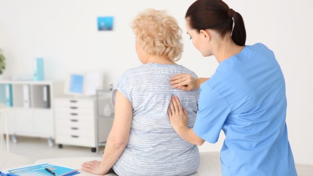 older woman at the doctor's office getting checked for osteoporosis