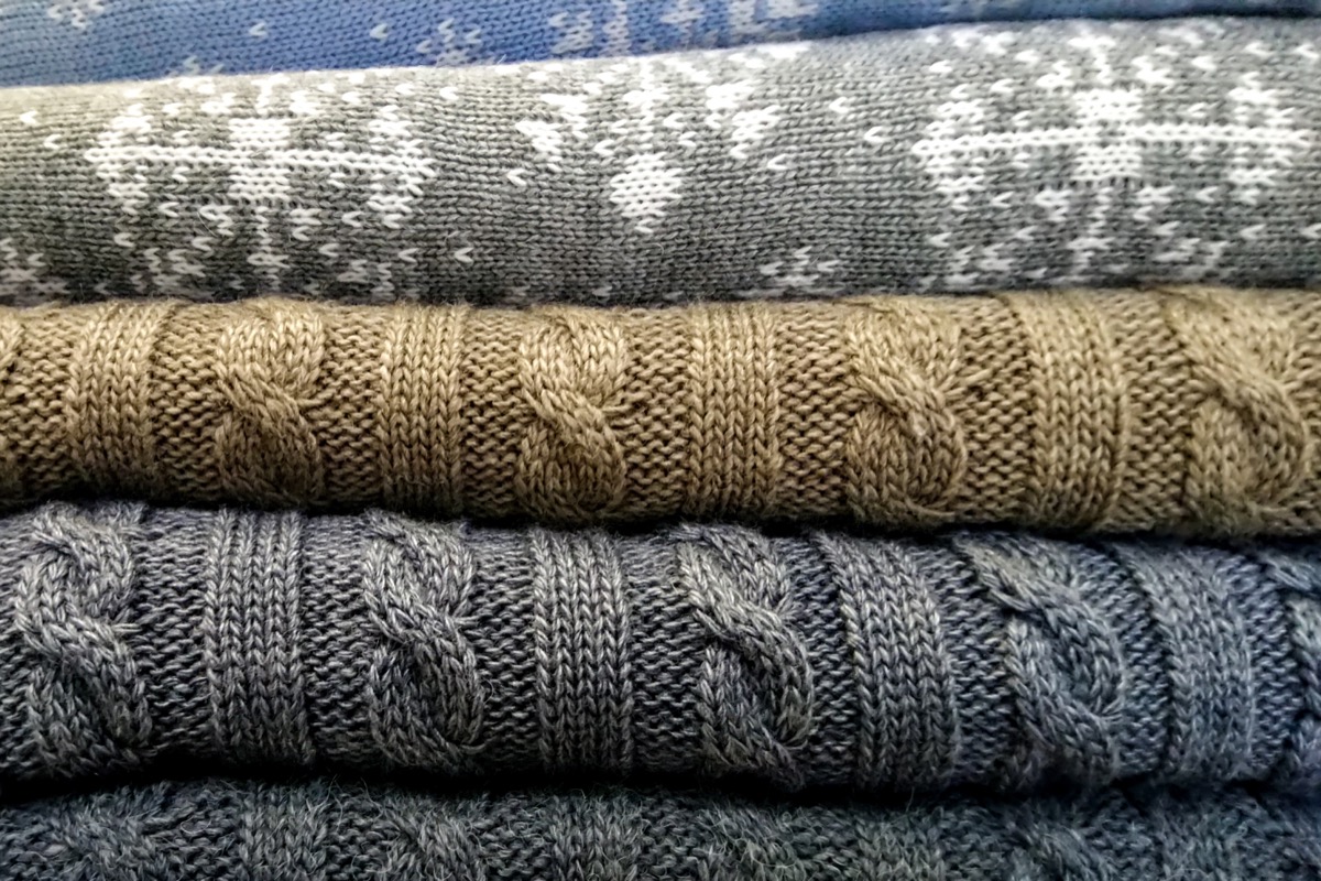pile of cozy winter sweaters, things you shouldn't store in your basement