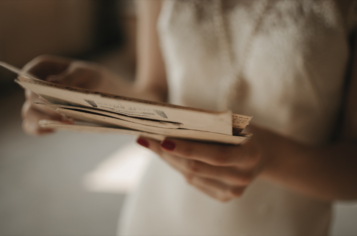 woman holding old love letters toss these things from your house for instant happiness