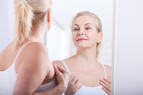woman looking in mirror, things husband should notice