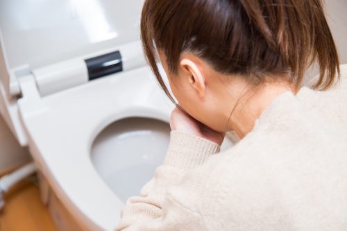 woman vomiting into toilet unexpected signs your heart is unhealthy