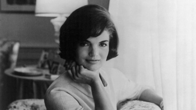 Portrait of Jackie Kennedy, Jacqueline Kennedy Onassis with hand on chin, leaning on couch