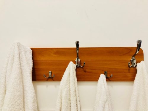 White towels hanging on hooks in bathroom, gross habits