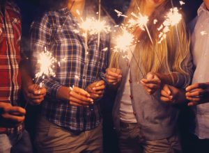 people holding sparklers outside, bug products