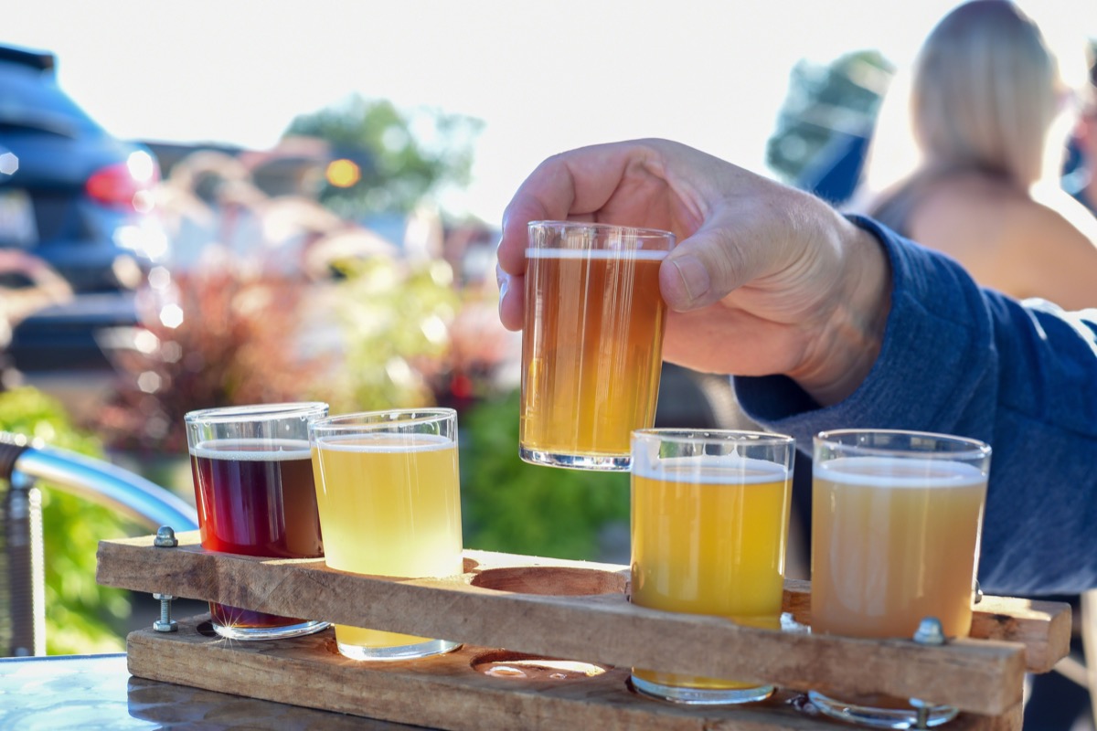 Man sampling a variety of seasonal craft beer at an outdoor beer garden